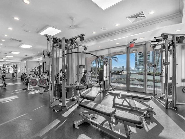 exercise room featuring crown molding