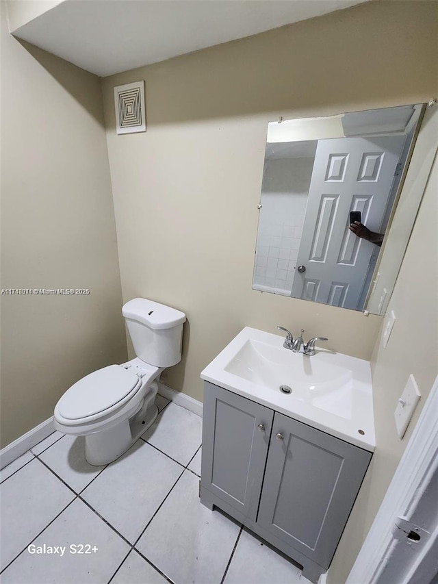 bathroom featuring tile patterned floors, vanity, and toilet