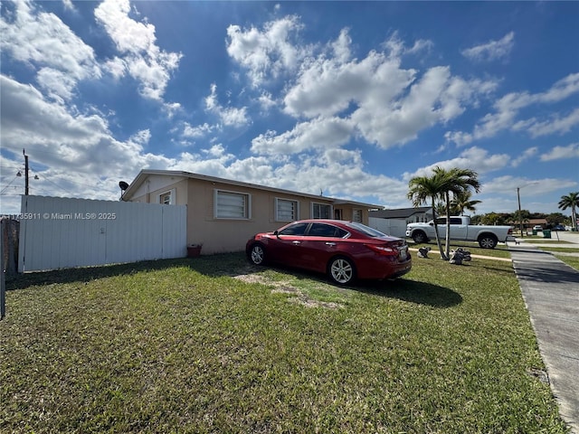 view of side of home with a lawn