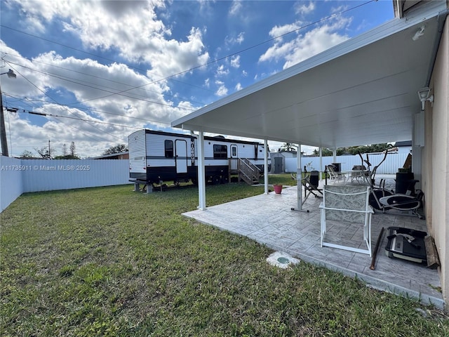 view of yard with a storage shed and a patio