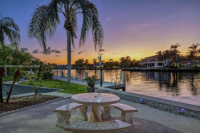 dock area featuring a patio and a water view