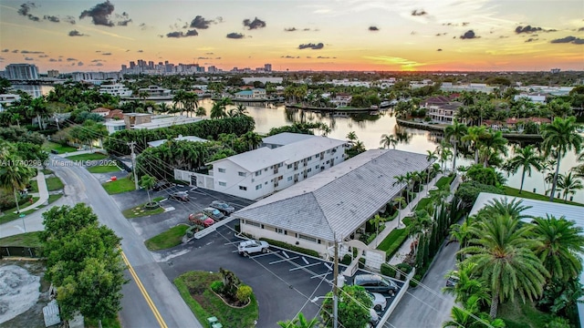 aerial view at dusk featuring a water view