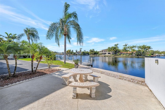 view of patio / terrace with a water view and a boat dock