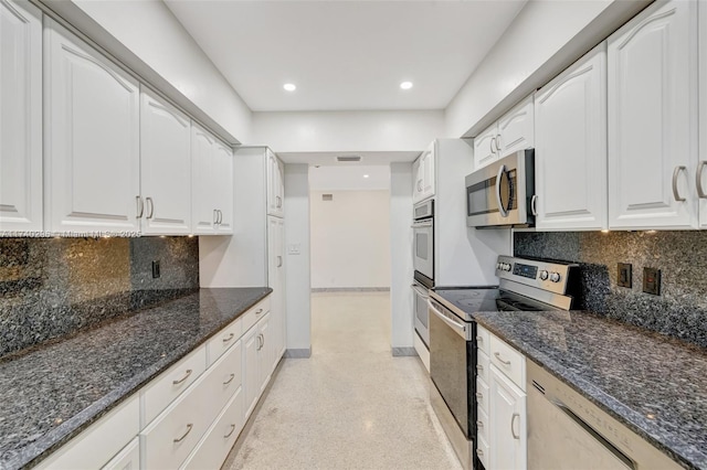 kitchen with backsplash, dark stone counters, white cabinets, and appliances with stainless steel finishes