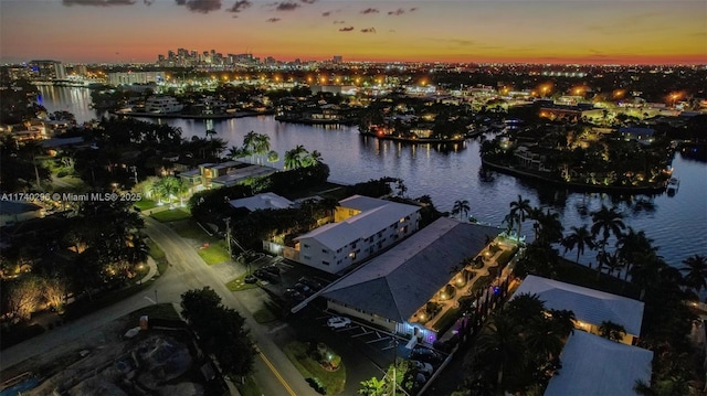 aerial view at dusk with a water view