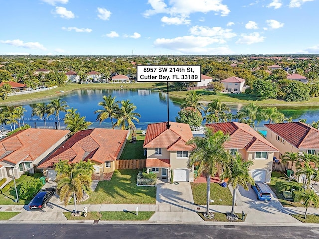 birds eye view of property with a water view and a residential view