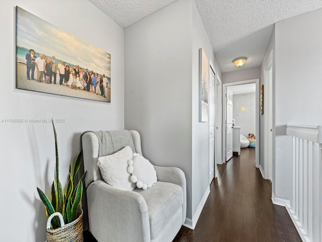 corridor featuring baseboards, a textured ceiling, and dark wood-style floors
