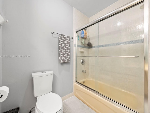 full bathroom with toilet, baseboards, and bath / shower combo with glass door