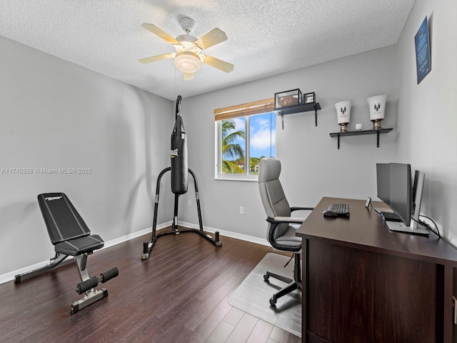 office space featuring ceiling fan, baseboards, a textured ceiling, and dark wood finished floors