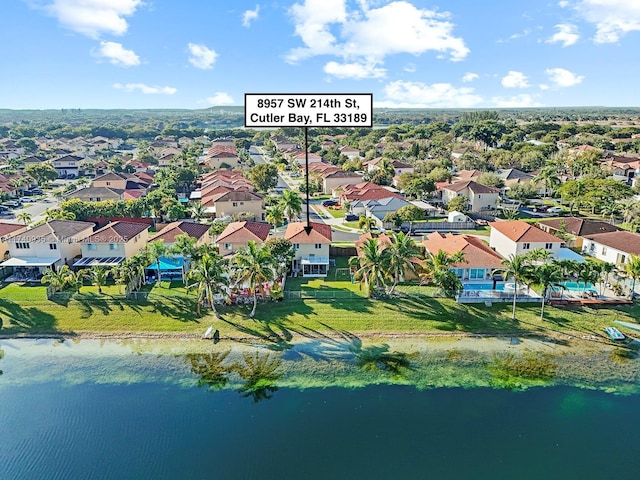birds eye view of property with a water view and a residential view
