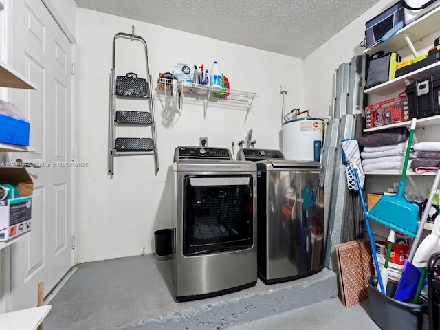 laundry room featuring washer and clothes dryer, water heater, and a textured ceiling