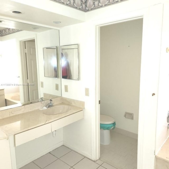 bathroom with a garden tub, vanity, visible vents, a closet, and tile patterned floors