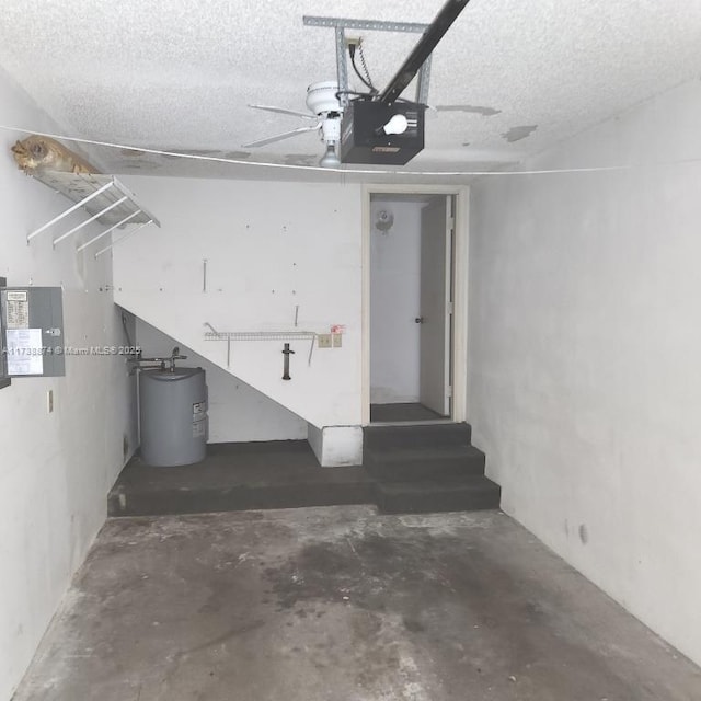 garage featuring electric water heater and a garage door opener