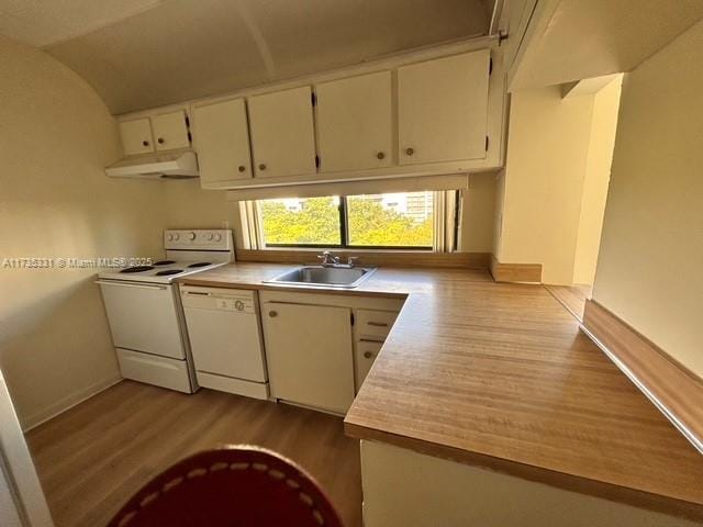 kitchen with hardwood / wood-style flooring, white cabinetry, sink, and white appliances