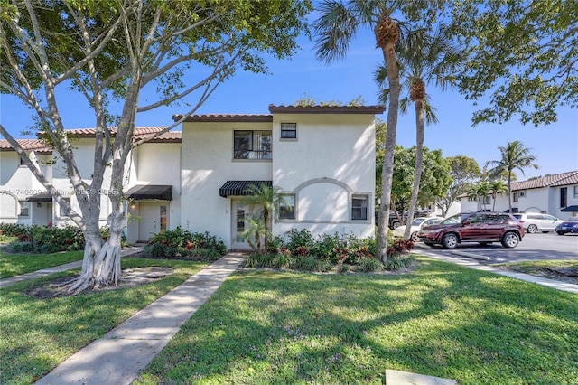 mediterranean / spanish-style home featuring a front lawn