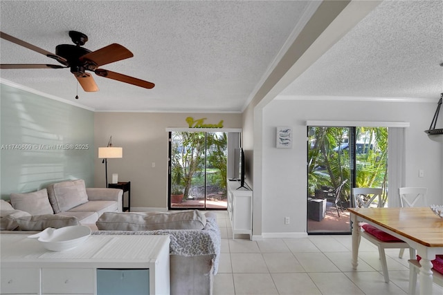 living room featuring crown molding, ceiling fan, a textured ceiling, and light tile patterned floors