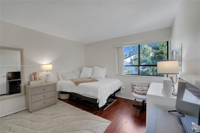 bedroom with wood-type flooring and a textured ceiling