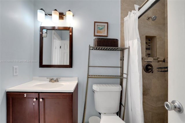 bathroom featuring vanity, a shower with shower curtain, and toilet