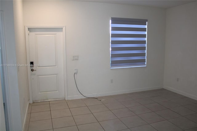 spare room featuring light tile patterned flooring