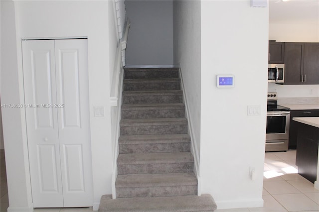 staircase featuring tile patterned floors