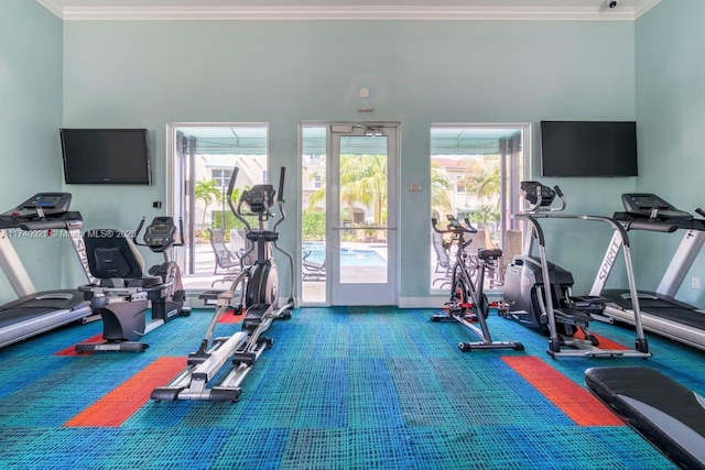 workout area featuring crown molding