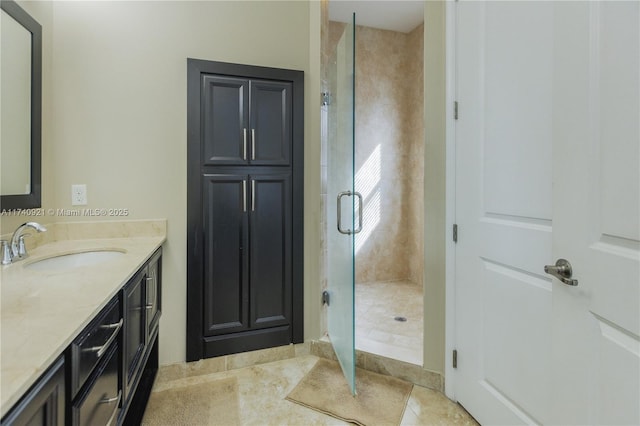 bathroom featuring vanity, tile patterned floors, and a shower with shower door