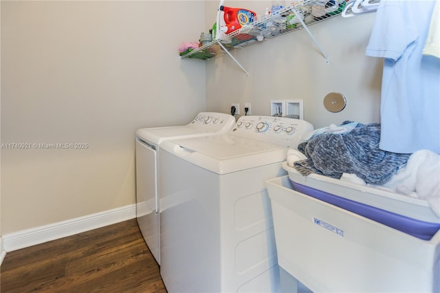 laundry room with separate washer and dryer and dark hardwood / wood-style flooring