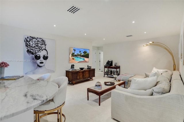 living room with light colored carpet, visible vents, and recessed lighting