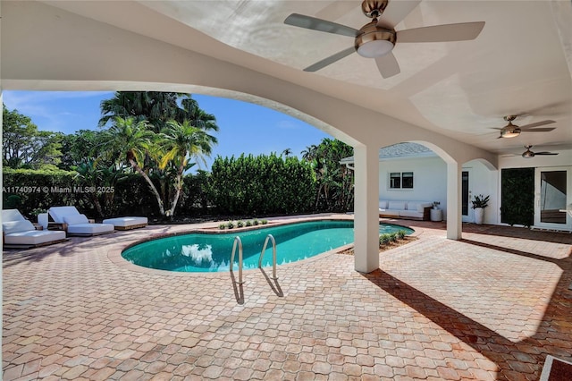 view of swimming pool featuring a patio area, a fenced in pool, and a ceiling fan