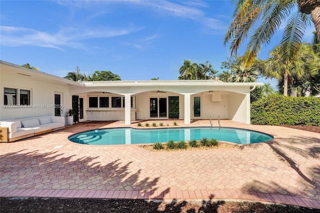 view of swimming pool with a fenced in pool, a patio area, ceiling fan, and outdoor lounge area