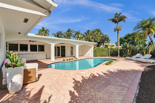 view of swimming pool featuring a patio area, ceiling fan, and a fenced in pool