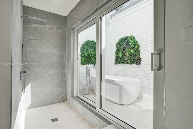 bathroom with a stall shower and tile patterned flooring