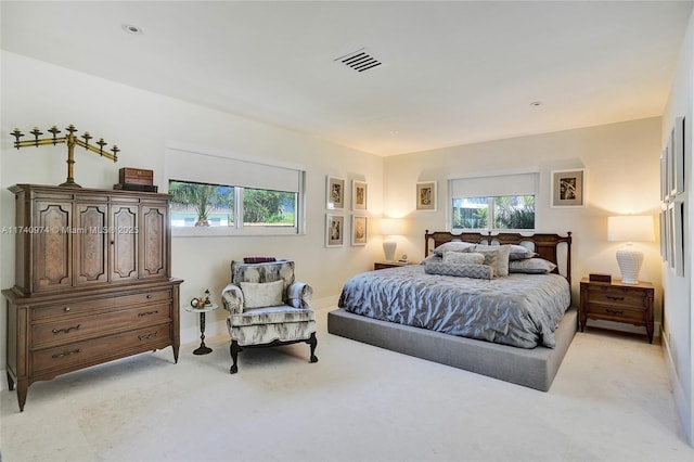 bedroom with baseboards and visible vents