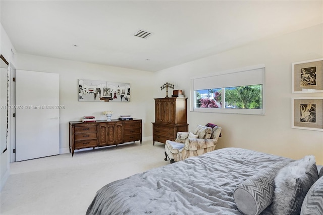 bedroom featuring baseboards, visible vents, and light colored carpet