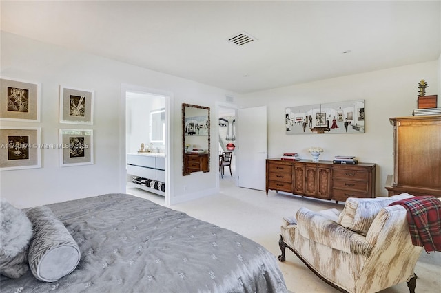 bedroom featuring light carpet, ensuite bath, and visible vents