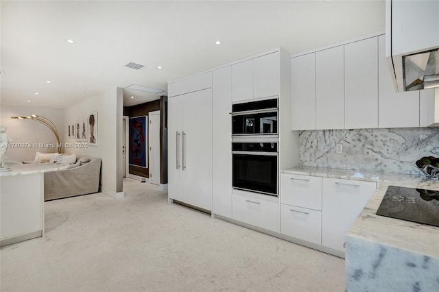 kitchen featuring white cabinets, visible vents, black appliances, and modern cabinets