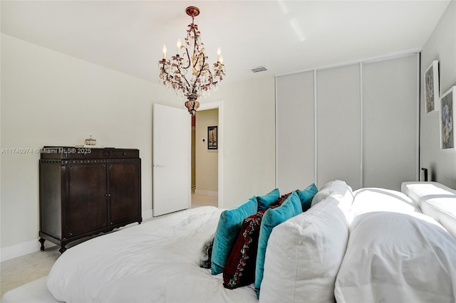 bedroom with an inviting chandelier, baseboards, visible vents, and a closet