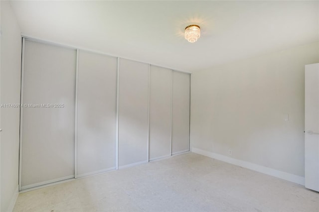 unfurnished bedroom featuring a closet and baseboards