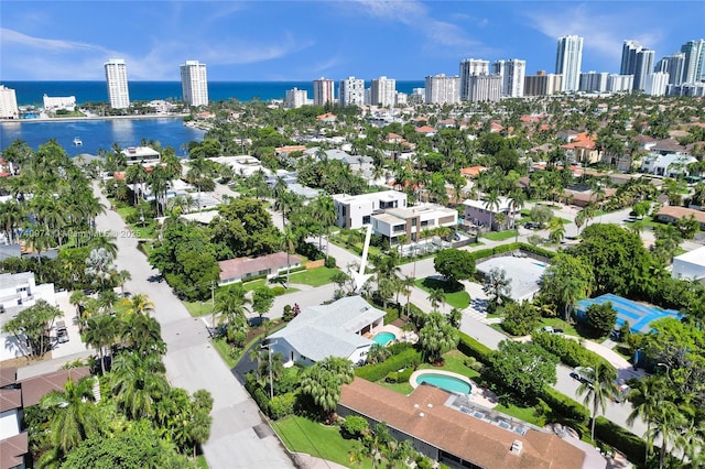 drone / aerial view featuring a view of city and a water view