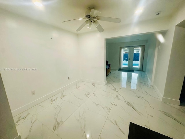 empty room featuring french doors and ceiling fan