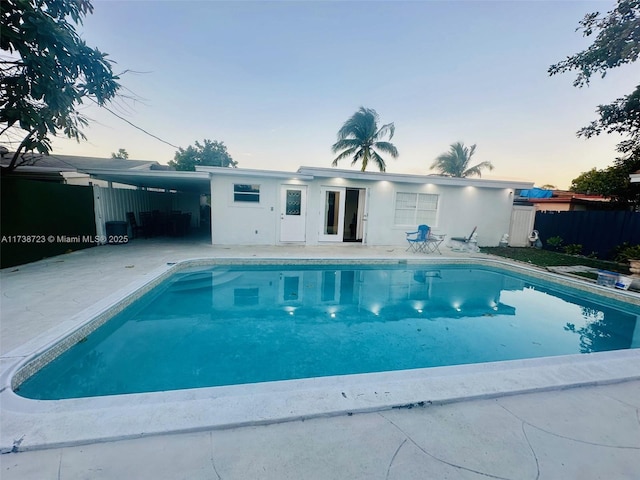 view of pool at dusk