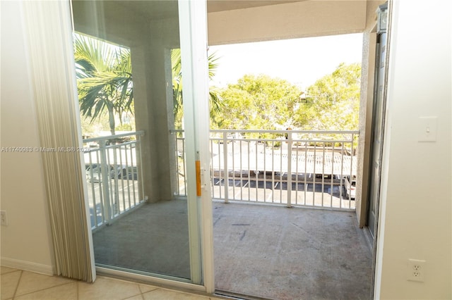 doorway with light tile patterned floors