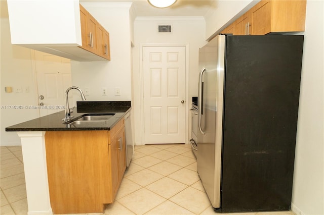 kitchen with dishwasher, sink, dark stone counters, ornamental molding, and stainless steel refrigerator with ice dispenser