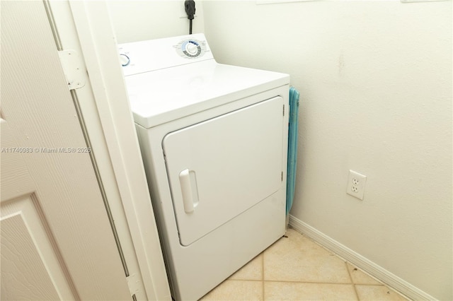 laundry area featuring light tile patterned floors and washer / dryer