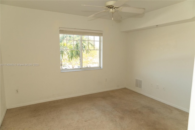 empty room featuring light carpet and ceiling fan