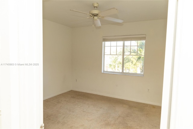 unfurnished room featuring ceiling fan and light colored carpet