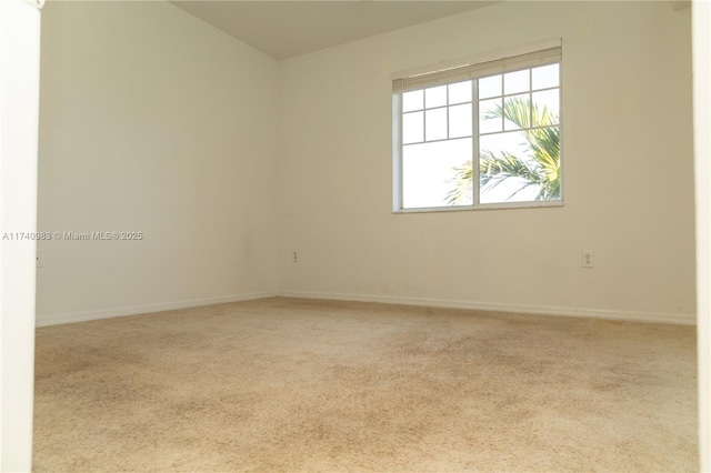 unfurnished room featuring light carpet