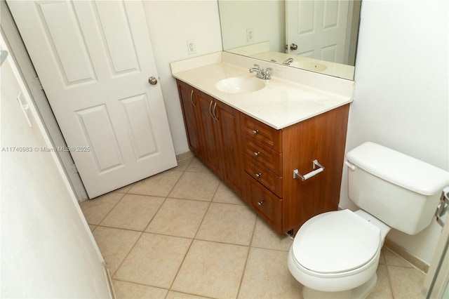 bathroom with vanity, tile patterned floors, and toilet