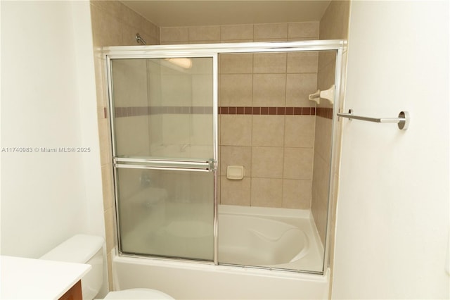 full bathroom featuring enclosed tub / shower combo, vanity, and toilet