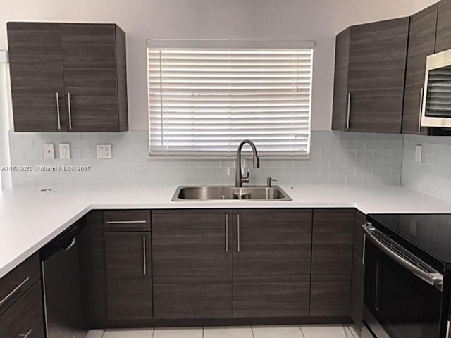 kitchen featuring black range with electric cooktop, a sink, dishwasher, and dark brown cabinets